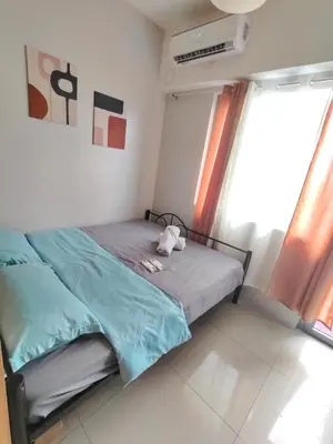 a dog laying on a bed in a bedroom at Condotels near NAIA in Manila