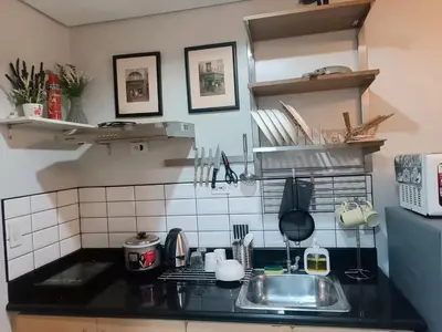 a kitchen with a sink and a counter top at Condotels near NAIA in Manila