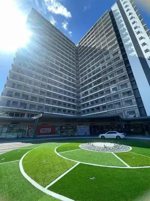 a large building with a fountain in front of it at Furnished Condo Unit-Green2 PoolWifiNetflix in Dasmariñas
