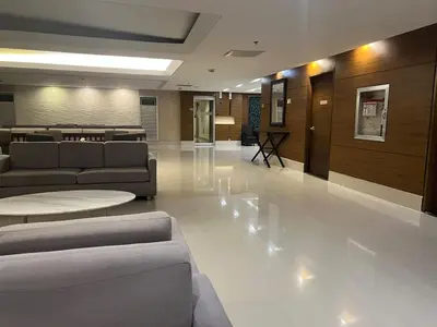 a lobby with couches and tables in a building at Condo Near World Trade, Star City and PICC - Amazing Breeze in Manila