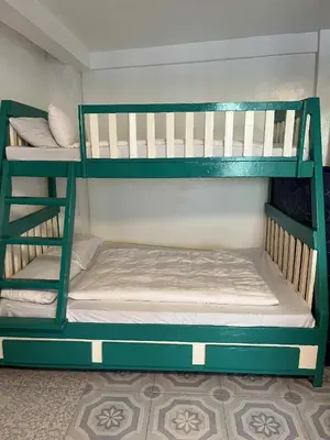 two green bunk beds in a room at Affordable Overnight Stay in Manila