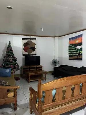 a living room with a christmas tree and a couch at Affordable Overnight Stay in Manila