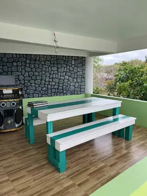 two benches in a room with a stone wall at Affordable Overnight Stay in Manila