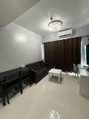 a living room with a couch and a table at Staycation By Abii in Manila