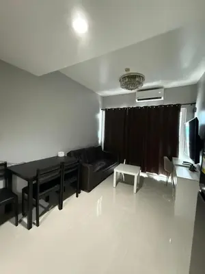 a living room with a couch and a table at Staycation By Abii in Manila