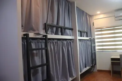 a walk in closet with gray curtains at YMCA Makati in Manila