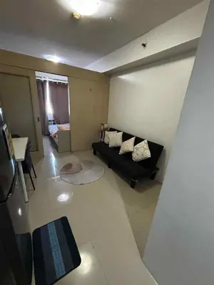a living room with a couch and a table at Elizas place in Manila