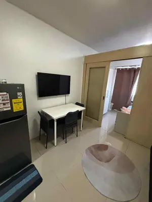 a living room with a white table and chairs at Elizas place in Manila