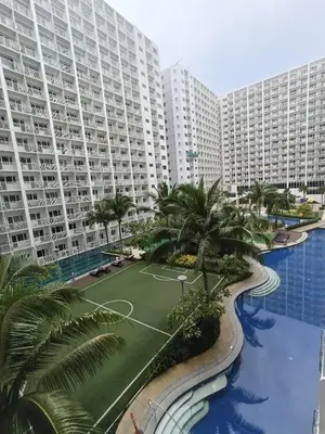 an aerial view of a large apartment complex with palm trees at Shore residences Tower D pool view Unit in Manila