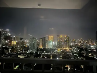 a view of a city skyline at night at Breeze Residences pasay near naia airport in Manila