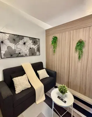 a living room with a couch and a table at Staycation by the Shore in Manila