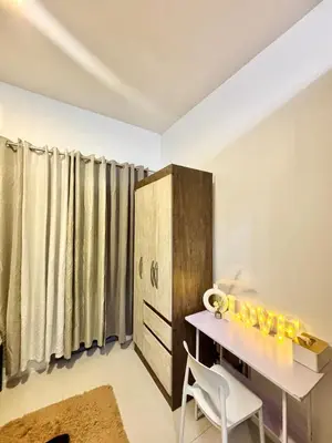 a dining room with a table and a cabinet at Relaxing City Retreat in Manila