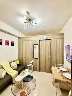 a living room with a couch and a table at Relaxing City Retreat in Manila