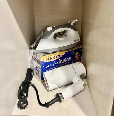 a toilet paper dispenser with a box and a box of toilet paper at Relaxing City Retreat in Manila