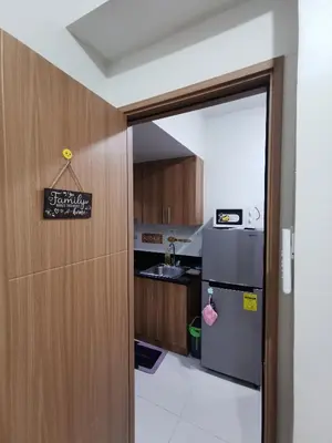an open door to a kitchen with a refrigerator at Mall of Asia residence Shore 3 in Manila