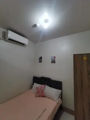 a bed in a room with a ceiling at Mall of Asia residence Shore 3 in Manila