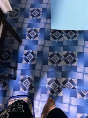 a person with their feet on a blue tiled floor at JhovenD in Manila