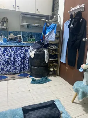 a room with a closet with clothes on racks at JhovenD in Manila