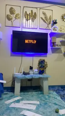 a television on a table in a room at JhovenD in Manila