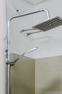 a shower head in a bathroom with a mirror at MOA Staycation at Shore 2 Residences Tower 1 in Manila