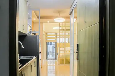 a kitchen with a sink and a refrigerator at MOA Staycation at Shore 2 Residences Tower 1 in Manila