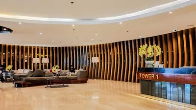a lobby of a hotel with a couch and a table at MOA Staycation at Shore 2 Residences Tower 1 in Manila