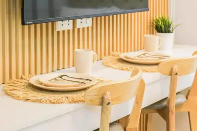 a dining room table with two chairs and plates on it at MOA Staycation at Shore 2 Residences Tower 1 in Manila