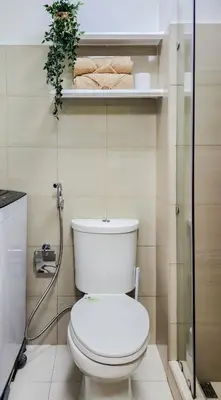 a bathroom with a white toilet and a shower at MOA Staycation at Shore 2 Residences Tower 1 in Manila
