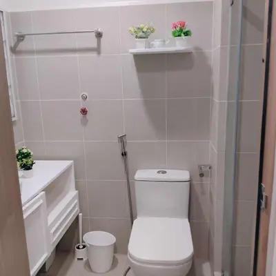 a small bathroom with a toilet and a shower at Homefort Twin Bed Suite - Red Residences Unit 2626 in Manila