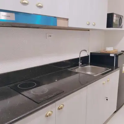 a kitchen with a sink and a counter top at Homefort Twin Bed Suite - Red Residences Unit 2626 in Manila