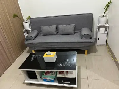 a living room with a couch and a coffee table at Peaceful Pasay Getaway - Private Studio with Pool in Manila