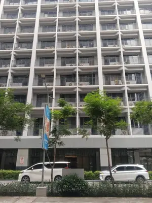 two cars parked in front of a large building at Peaceful Pasay Getaway - Private Studio with Pool in Manila
