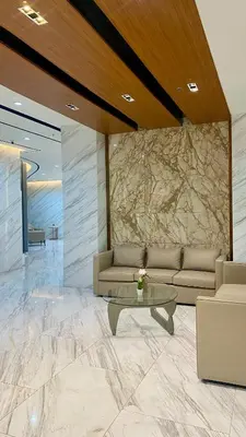 a living room with a couch and a table at Grand View Tower Queen Bed Modern Condo in Manila