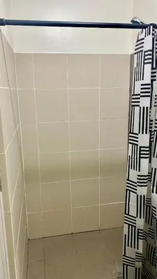 a shower with a black and white shower curtain at Grand View Tower Queen Bed Modern Condo in Manila