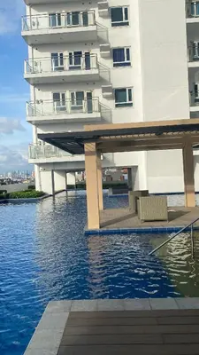a building with a bridge over a body of water at Grand View Tower Queen Bed Modern Condo in Manila