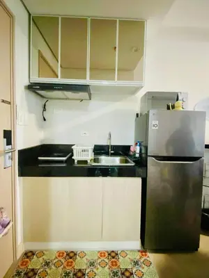 a kitchen with a stainless steel refrigerator and a sink at SMDC Park Residences Condo Unit 417 near SM City Sta Rosa in Ibaba