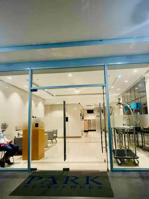a glass door of a building with a person sitting in a room at SMDC Park Residences Condo Unit 417 near SM City Sta Rosa in Ibaba