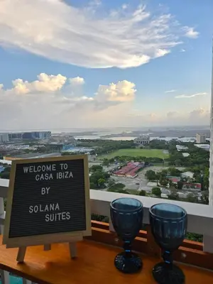 a sign on a balcony with two wine glasses at Bay View near US Embassy, Airport in Manila