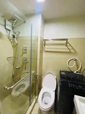 a bathroom with a toilet and a shower and a sink at Shore Residence 3 tower 1 Amenity view MOA Terminal 3 in Manila