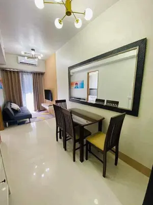 a living room with a dining room table and chairs at Shore Residence 3 tower 1 Amenity view MOA Terminal 3 in Manila