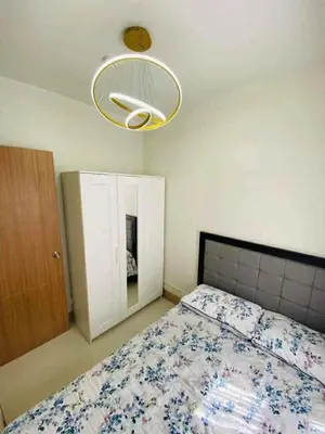 a bedroom with a bed and a light at Shore Residence 3 tower 1 Amenity view MOA Terminal 3 in Manila