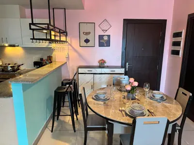 a kitchen with a table with chairs and a dining room at Uptown Parksuites Tower 2 4BR in BGC Taguig in Manila