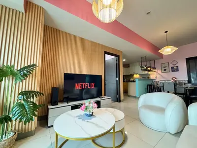 a living room with a television and a table at Uptown Parksuites Tower 2 4BR in BGC Taguig in Manila
