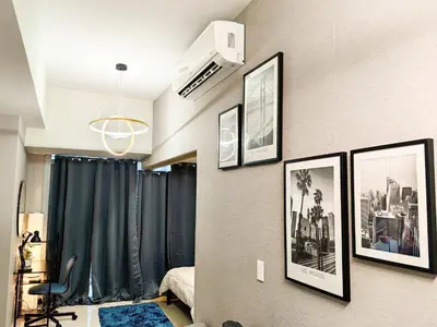 a room with framed pictures on the wall at Charming 1BR in Uptown Parksuites Tower 2 BGC in Manila