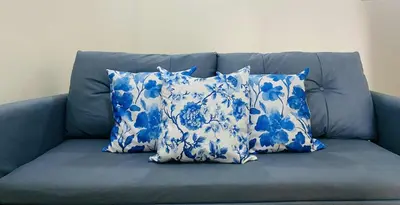 two blue and white pillows on a blue couch at V-TAN house in Manila