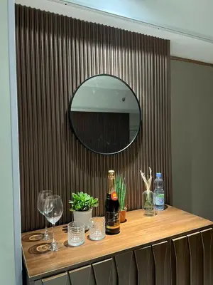 a table with wine glasses and a mirror on it at East Glory PentHouse in Manila