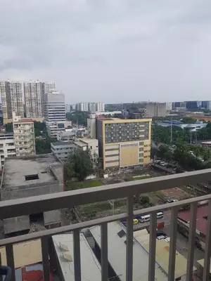 a view of a city from the balcony of a building at Cozy Coast Residences Pasay in Manila
