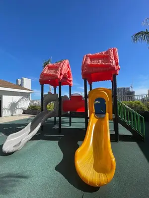 a playground with a slide and a slideintend at Cozy Coast Residences Pasay in Manila