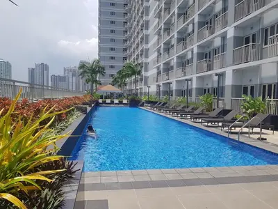 a swimming pool in the middle of a building at Cozy Coast Residences Pasay in Manila