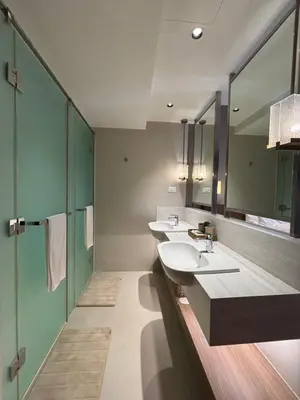 a bathroom with two sinks and a large mirror at The hotel residences at Acqua in Manila